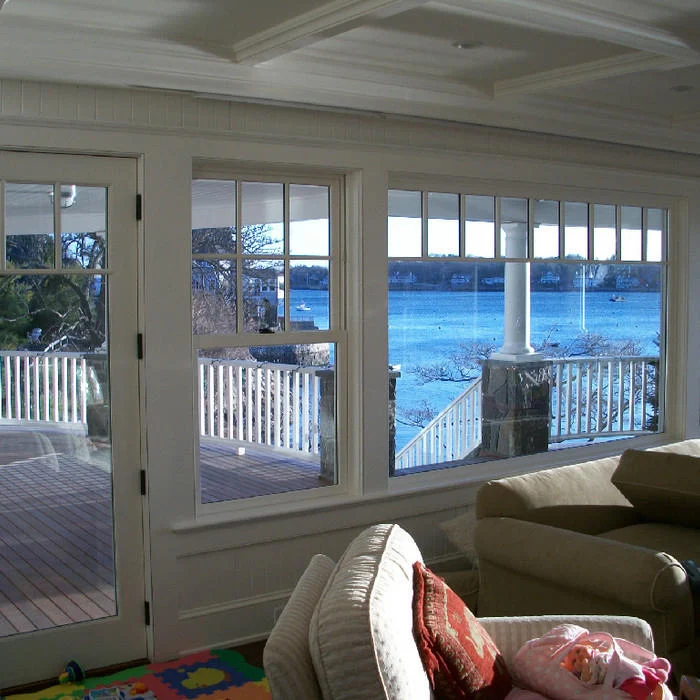 Sunroom interior with water/harbor view through large windows