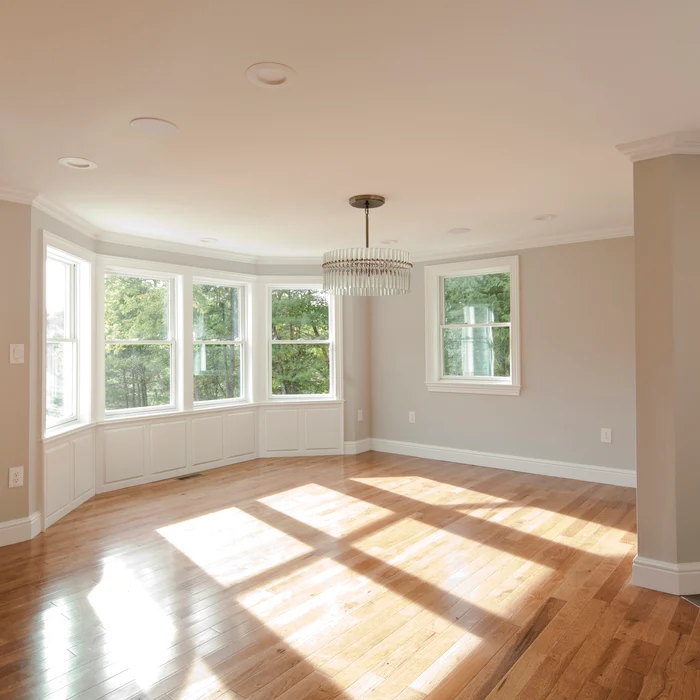 Bay-window room with hardwood floor and chandelier