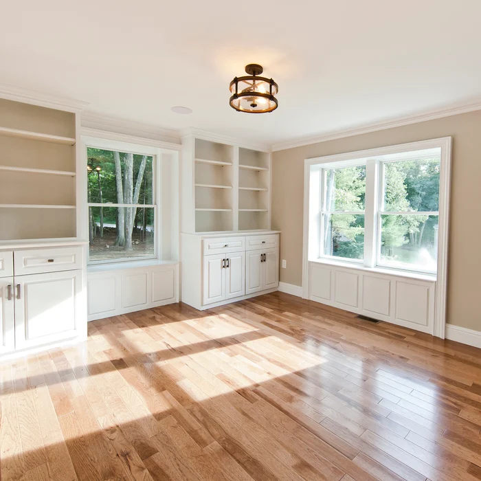 Home office/den with built-in shelving and cabinetry