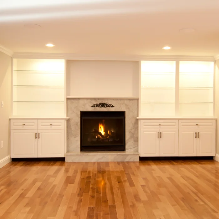 Renovated kitchen with white cabinetry, center island, and pendant lighting