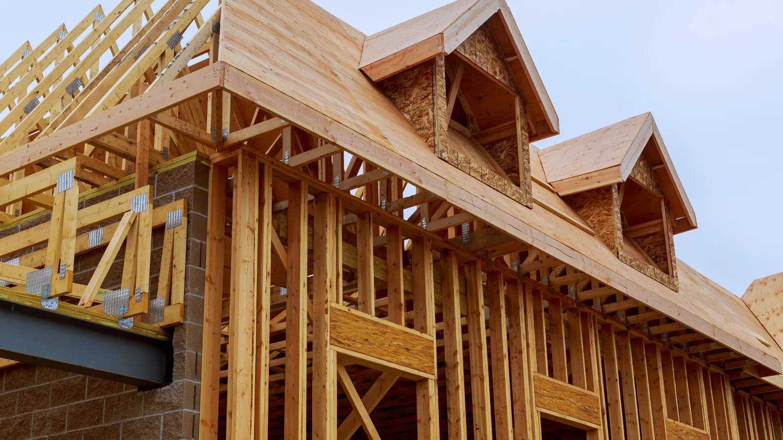 New home under construction with wood framing — stock photo for general reference, not an MCG project